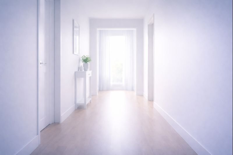 an empty hallway with soft daylight at the end, quiet atmosphere, minimal details, a sense of relief