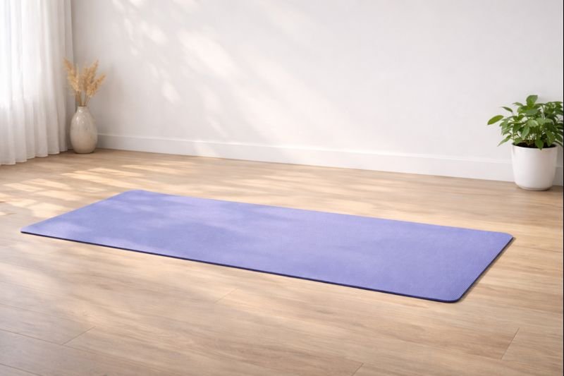 a plain yoga mat in an empty room, neutral tones